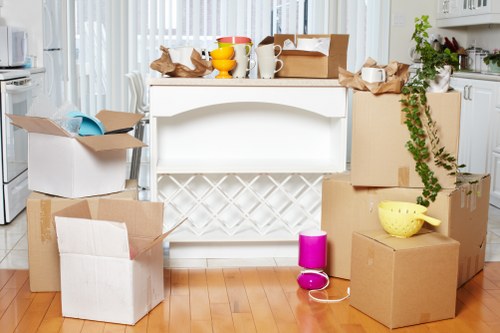 Professional movers carrying furniture through a residential hallway