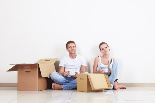 Removalists carrying household items through a residential property